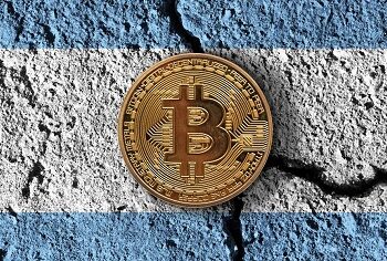 Bitcoin crypto currency coin with cracked Argentina flag. Crypto restrictions.